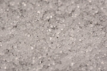Close-up of the surface of white salt grains, macro salt