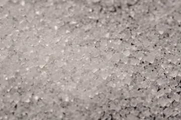 Close-up of the surface of white salt grains, macro salt