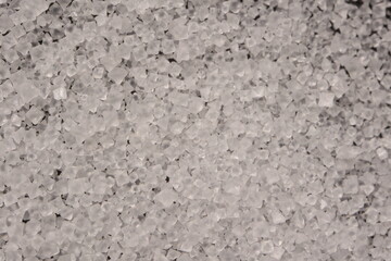 Close-up of the surface of white salt grains, macro salt