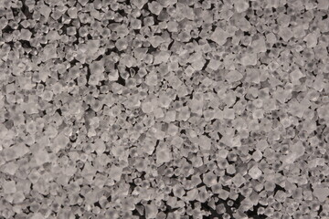 Close-up of the surface of white salt grains, macro salt