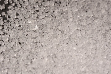 Close-up of the surface of white salt grains, macro salt