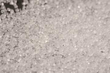 Close-up of the surface of white salt grains, macro salt