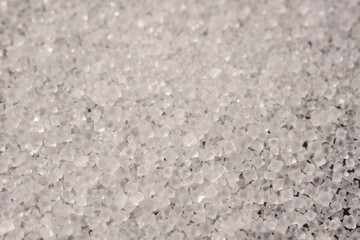 Close-up of the surface of white salt grains, macro salt