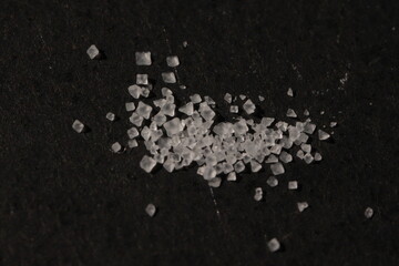 Close-up of the surface of white salt grains, macro salt
