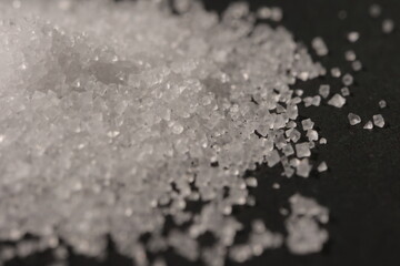 Close-up of the surface of white salt grains, macro salt