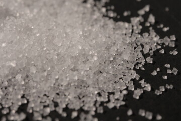 Close-up of the surface of white salt grains, macro salt