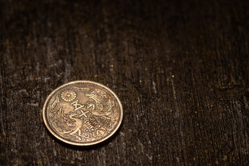 Showa 50 sen an old japanese fifty sen coin from showa era sits beautifully on aged wood. © Mr