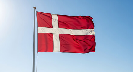The danish flag waving proudly against a clear blue sky on a sunny day