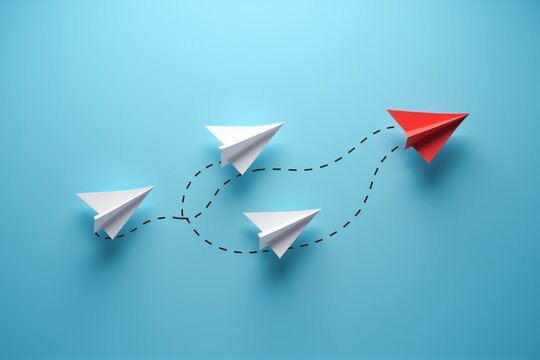White paper plane leads two red ones on dotted path, symbolizing guidance and teamwork against a calm blue backdrop.
