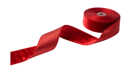 A spool of luxurious red velvet and satin ribbon unspools into an elegant flowing shape