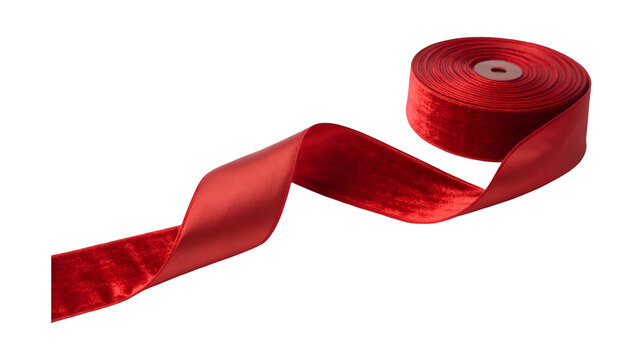A spool of luxurious red velvet and satin ribbon unspools into an elegant flowing shape