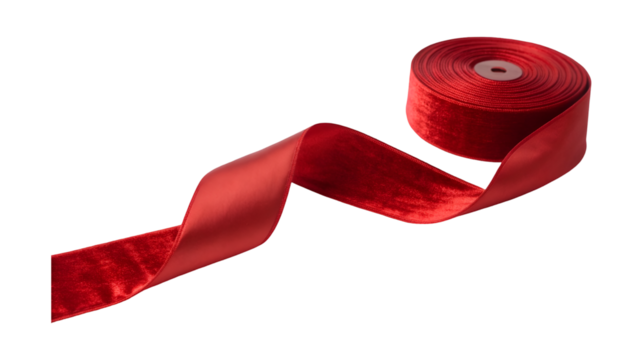 A spool of luxurious red velvet and satin ribbon unspools into an elegant flowing shape
