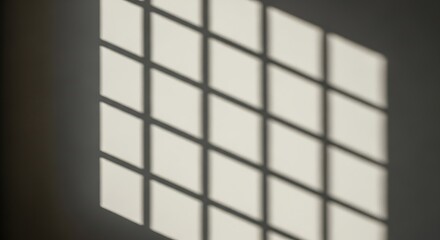 Shadow of window frame creates a geometric pattern on the wall