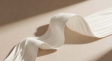 Elegant flowing white fabric with soft shadows on a beige background