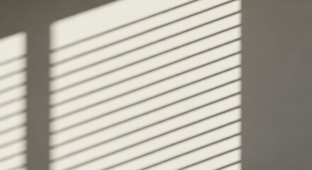 Shadows from window blinds create abstract patterns on a white wall