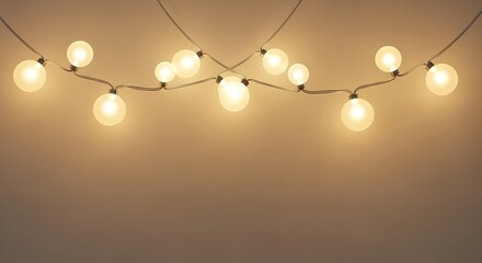 String of warm glowing fairy lights hanging against a neutral background