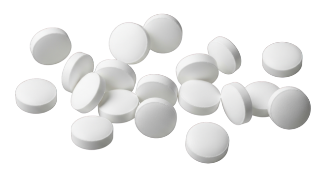 White pills scattered on a white surface medicine concept.