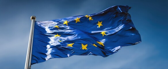The European Union flag waving majestically against a dramatic cloudy sky backdrop