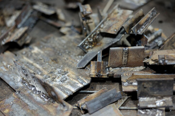 Scrap metal fragments scattered on the assembly floor in industrial manufacturing facility