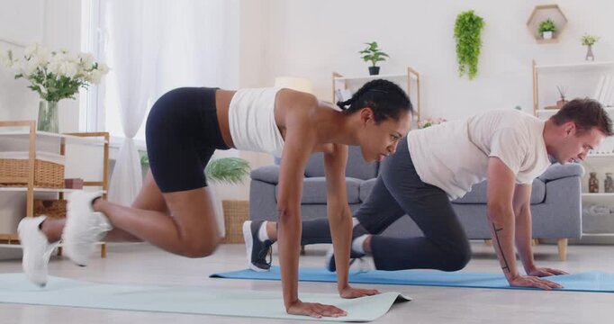 Couple fitness workout doing sport exercise at home. Sporty man and woman exercising on mat in living room for health, gaining strength with endurance training. Training and healthy lifestyle.  - Powered by Adobe
