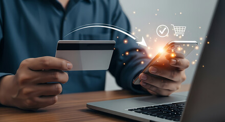 A person securely uses a credit card for online shopping on a laptop, with digital payment symbols illuminating the transaction process.
