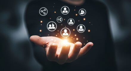A person's hand holding a glowing digital network of connected people, symbolizing social media and online connections for business.