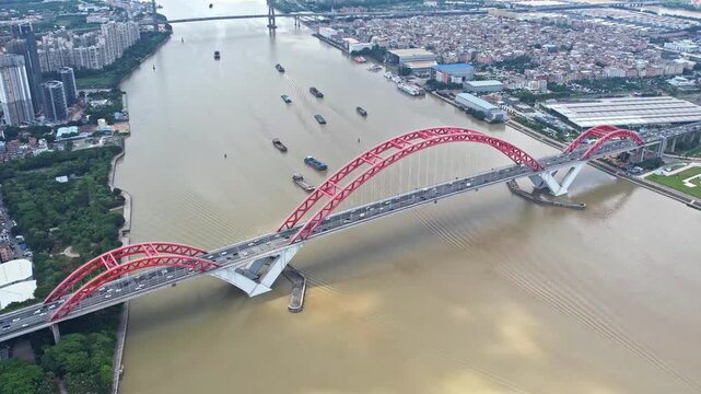 Guangzhou Haizhu District Red Arch Bridge Aerial View Over Pearl River with City Skyline and Boats