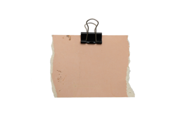 Torn pastel beige paper sheet with black binder clip isolated on white background, ripped textured craft paper for notes, messages, invitations, scrapbooking, stationery design