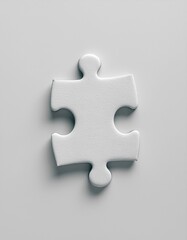 Obraz premium A single white puzzle piece rests on a smooth, light gray background from above.