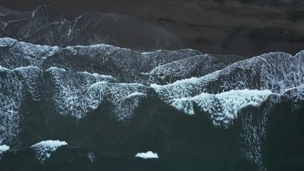 Aerial view of a serene coastline with gentle waves and natural seascape, shot by drone in Japan.