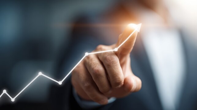 Finger touches glowing line graph indicating upward trend and success