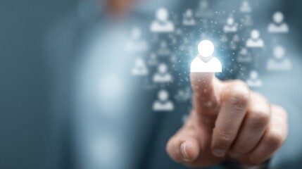 Finger touching glowing user icon among blurred network silhouettes