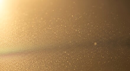 Abstract golden surface with sparkling dust particles and soft light