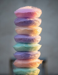 Stack of colorful cotton candy against a neutral background.