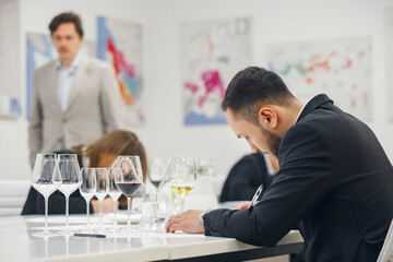Sommelier examination to get certificate professional work of winemaking. Blind wine tasting. Sommelier degustate wine.