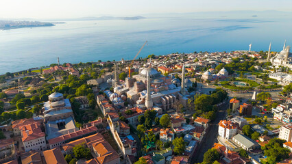 Istanbul, Turkey. Drone flyaway from Hagia Sophia to panoramic view with Blue Mosque and Sultanahmet Square rooftops and sea. Aerial View