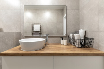 Modern Bathroom Interior with Wooden Countertop and Round Sink