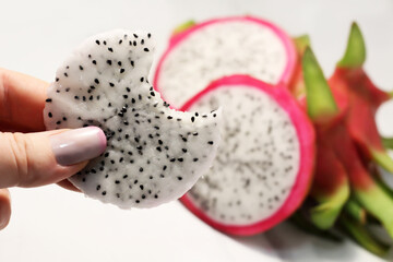 A piece of Pitahaya in hand. An exotic, pink, delicious fruit from Thailand.