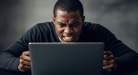 African american man looking at laptop screen with angry expression, showing frustration, anger and a bad mood for workplace and technology concept.