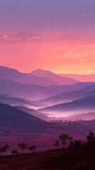 Serene sunrise over a misty valley, showcasing layers of purple and pink-hued mountains fading into a soft, ethereal dawn.  Low-lying fog blankets the valley floor