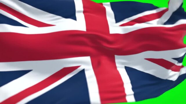The Union Jack the national flag of the United Kingdom waves proudly in the wind against a vibrant green screen background symbolizing national identity and patriotism.