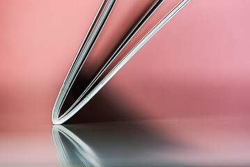 Minimalist close-up of an open notebook forming geometric lines on a uniform background