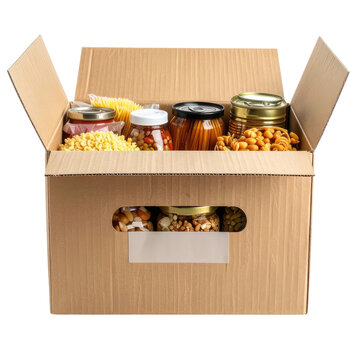 Cardboard box overflowing with various canned and packaged food items, open