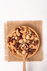 Mixed nuts consisting of almonds, cashews and peanuts, roasted with salt. Healthy snack on white background.
