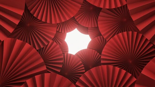 Abstract tunnel effect created by overlapping red pleated paper fans forming a vibrant, decorative geometric background with a central glow