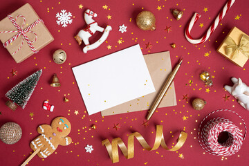 New Year and Christmas holiday decoration objects on red background with blank white paper sheet space in center