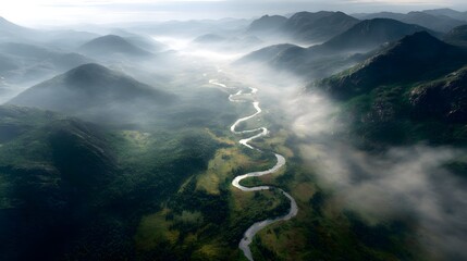 Winding river flowing through misty mountains aerial view nature scene tranquil environment
