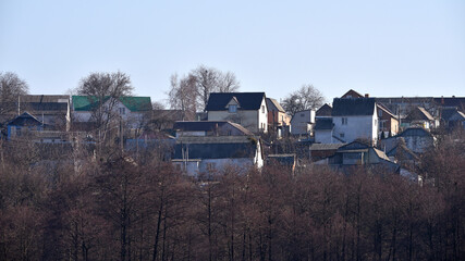 house in nature, in a rural area. a country house for recreation. landscape, nature. traditional green and brown roofs of houses in the rural area of the during autumn or fall. park near the house