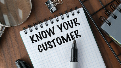 A notebook with the words "Know Your Customer" written on it