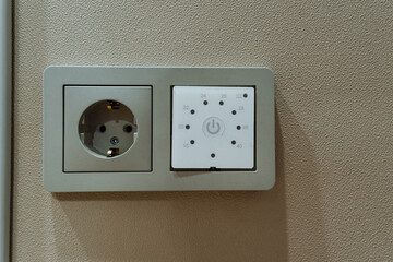electrical setup preview, wall socket with mounting details, closeup of electrical panel and mounting holes, beige wall feature with exposed metal connector pattern ready for switch